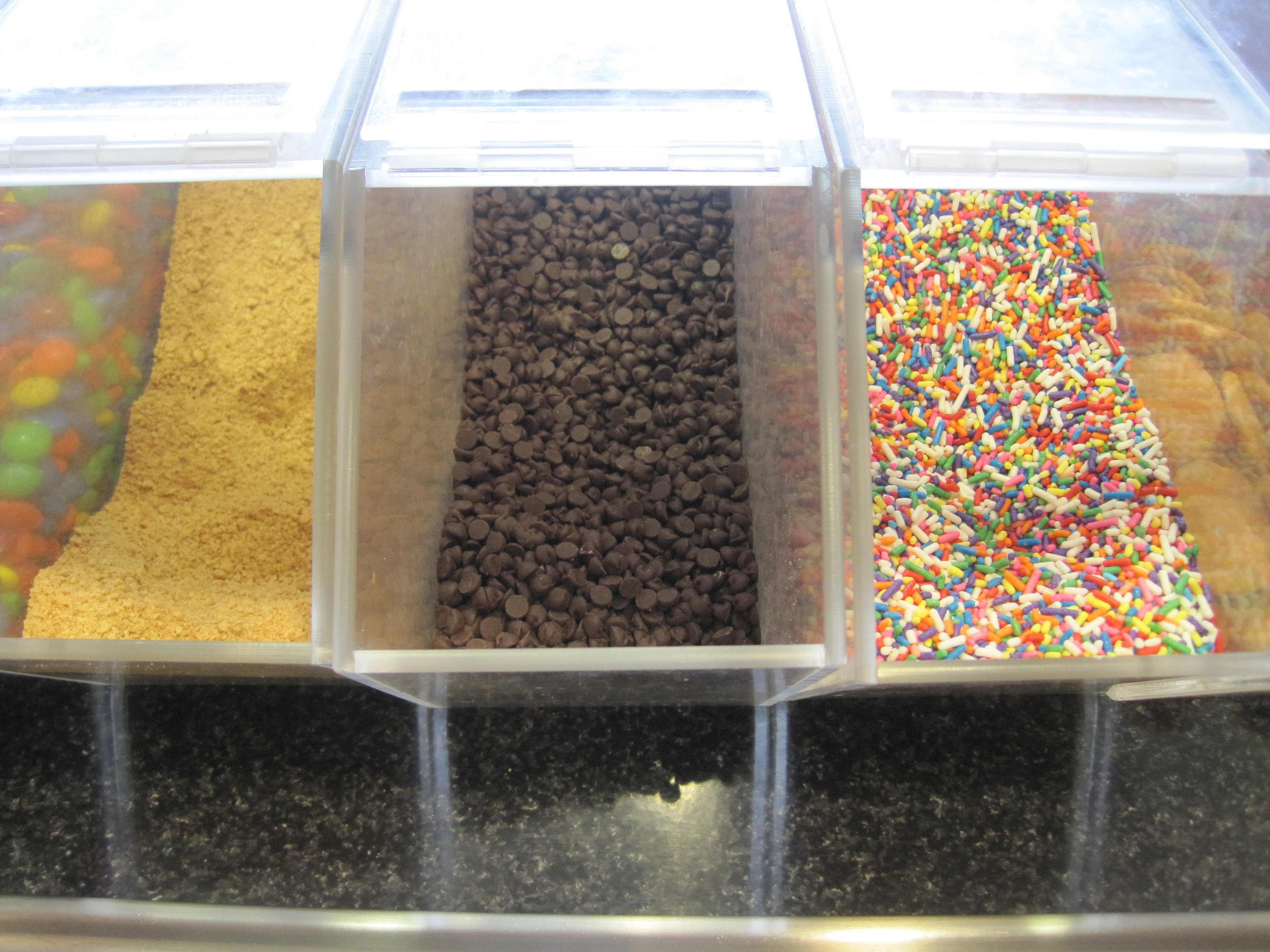 Dessert toppings bar with sprinkles and chocolate chips